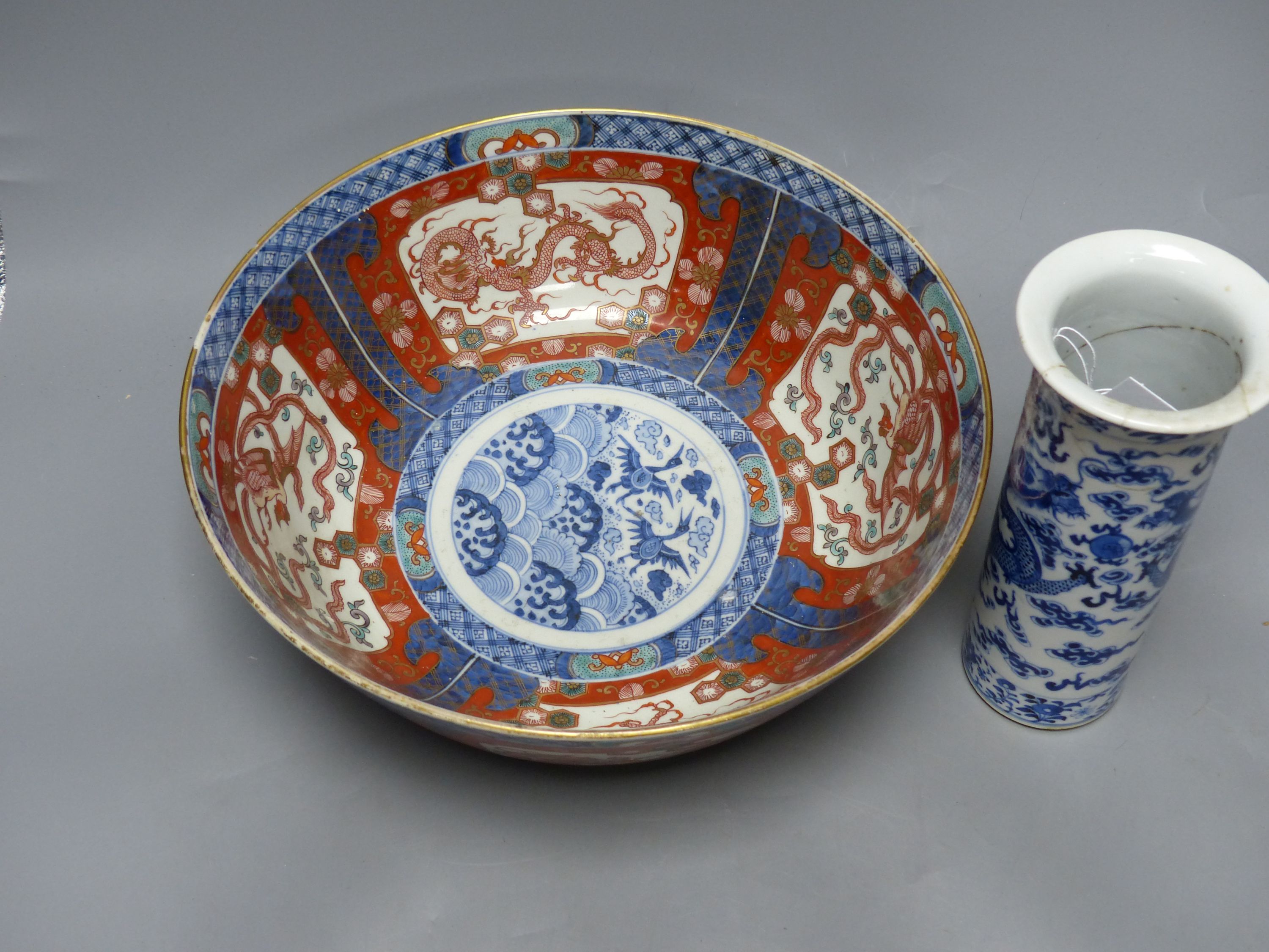 A large Japanese Imari bowl, Meiji period, diameter 31cm, and a Chinese blue and white sleeve vase